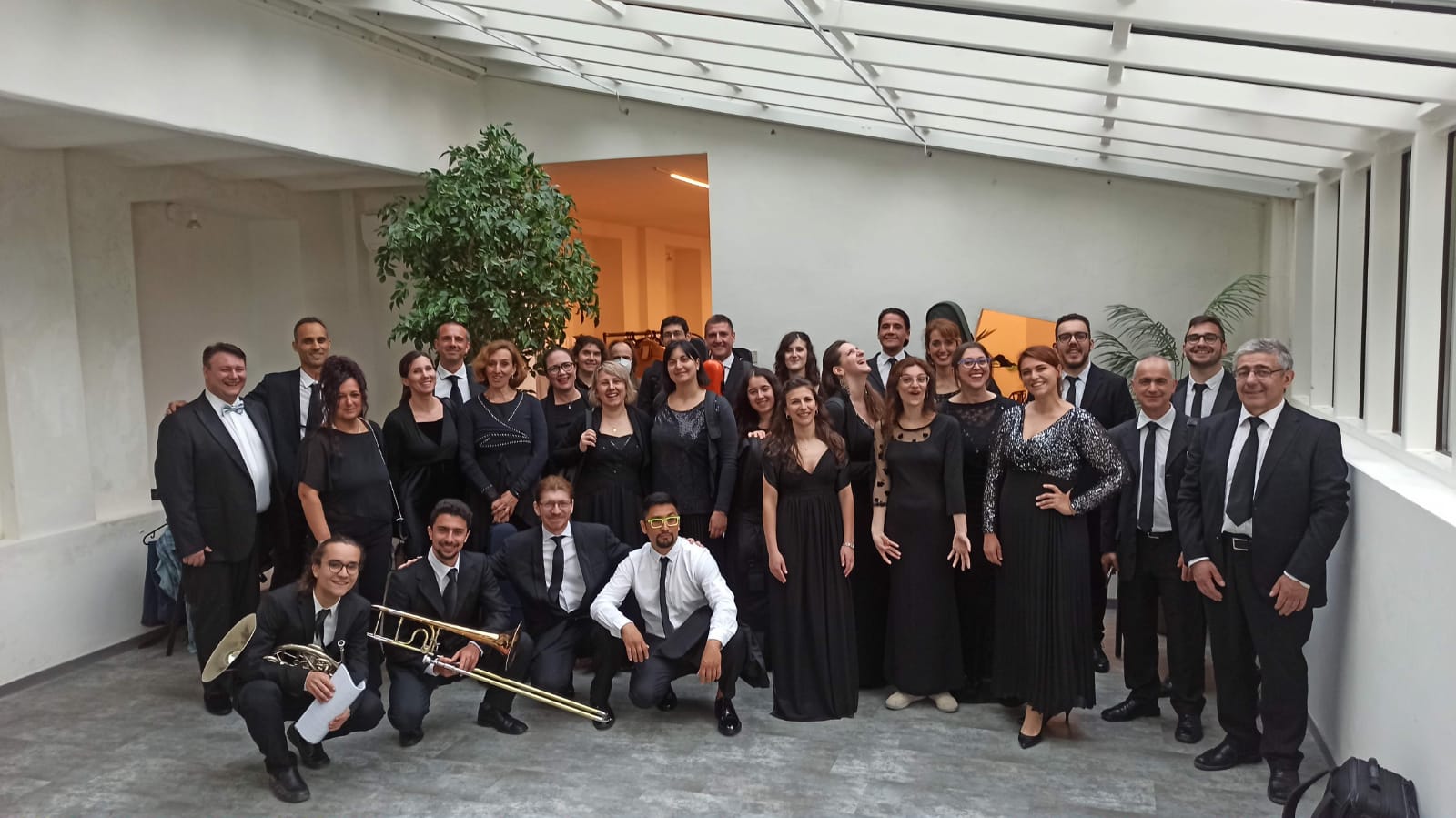 symphony orchestra posing for a backstage picture before the performance in Lake Como